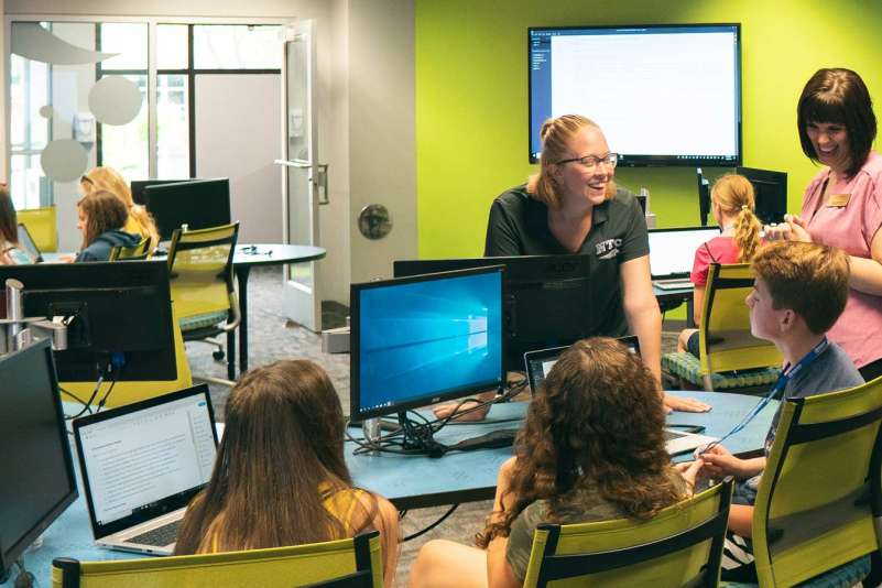 A group of prospective students listen to NTC staff while seated in a room near the iTEC during a tour of the NTC Wausau Campus.