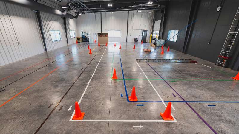 Orange cones are strategically placed inside of a facility for the purposes of testing a candidates physical strength.