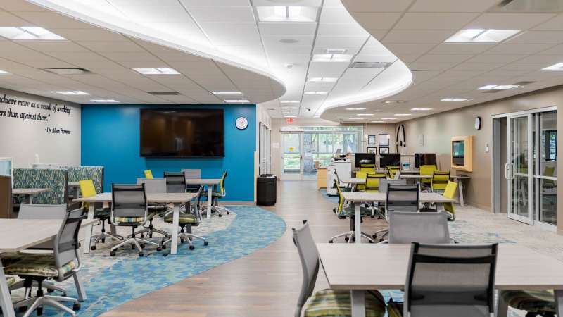 The inside of the STEM Center, featuring several tabletop workspaces and computers.