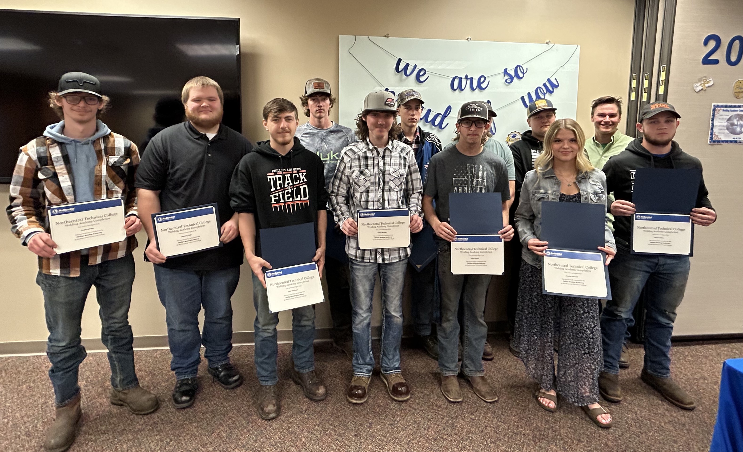 Phillips Welding Academy students posing with their completion certificates.