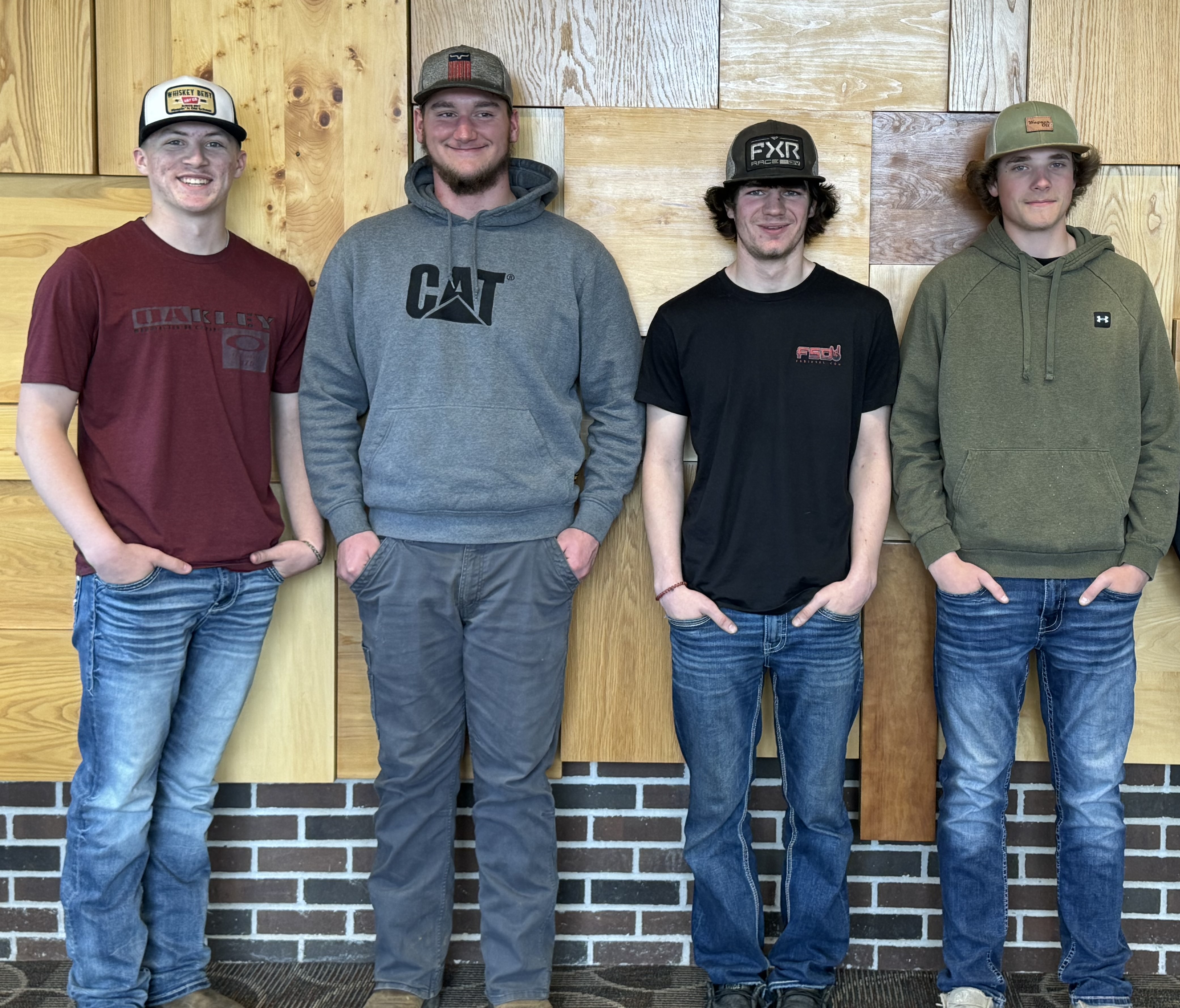 Antigo Advanced Welding Academy students posing while standing against a wall.
