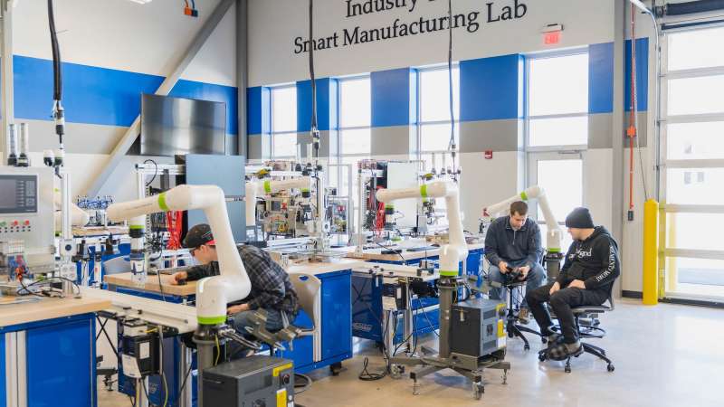 A wide-view of NTC's Smart Manufacturing Lab, where students cooperate while manipulating industrial robots.