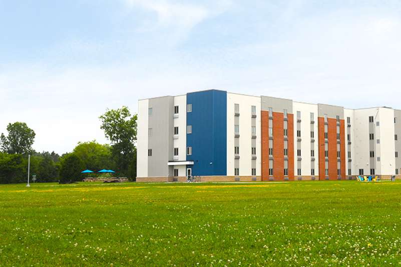 An external view of the Timberwolf Suites building on a bright summer day
